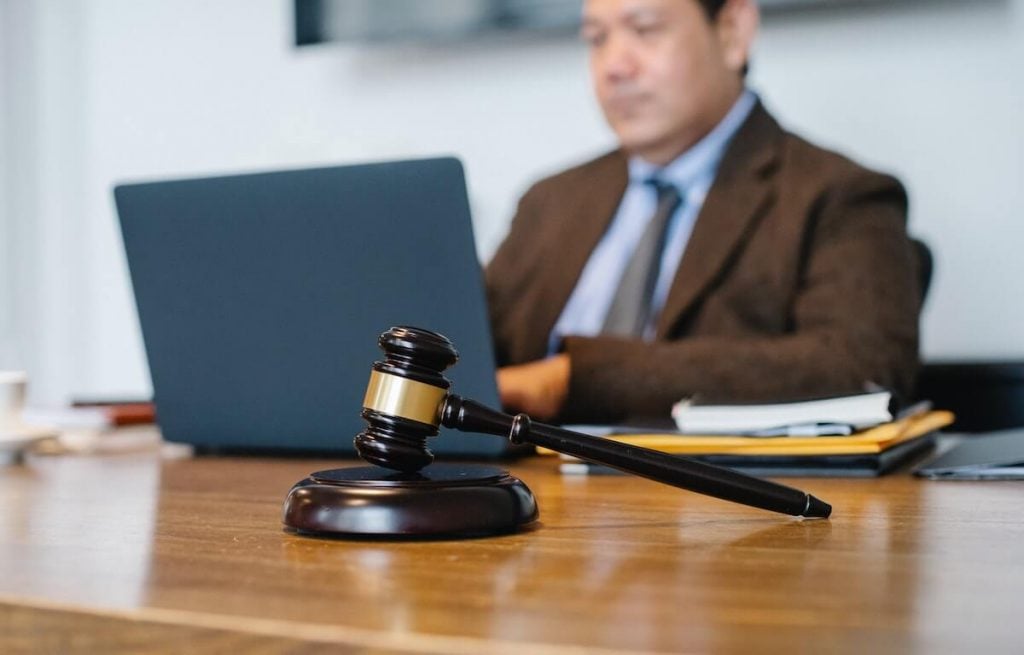A lawyer sitting at a desk on a laptop.